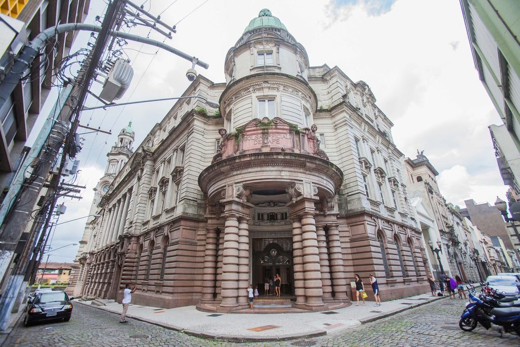 Fachada imponente do prédio da antiga Bolsa do Café, hoje Museu do Café, com cúpula e colunas, numa esquina do centro de Santos